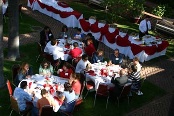 view from above of three tables of alumni in the south quad court yard