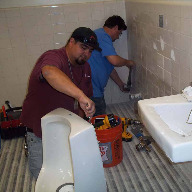 Plumbers installing new bathroom fixtures