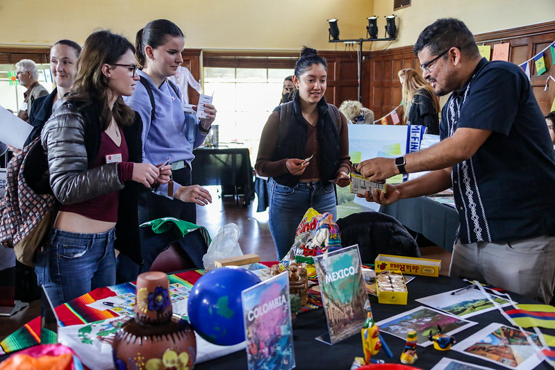 Student attendees and faculty member at Colombia and Mexico table