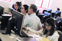 teacher helping students in PC lab