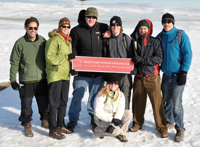 Students and Advisors from BIO/POLS 345 stand on frozen Arctic Ocean