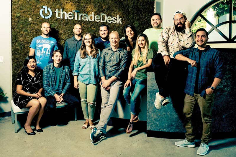 Trade Desk founder and CEO, Jeff Green, shown with other members of his team, including CSUCI as well as other CSU alums. Front row (from left to right): Valerie Valdez, Taylor Tally, Katherine Armstrong, Jeff Green, Miranda Jordan, Lenin Jaime, Jimmy Bañales; Back row (from left to right): David Zych, Ryan Anderson, Thomas Hamlin, Melanie (Milam) Polishchuk, Henry Valdez