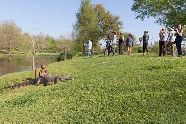 Students observe “Boots” a seven-foot long alligator
