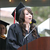 member of inaugural freshman class giving speech to new graduates