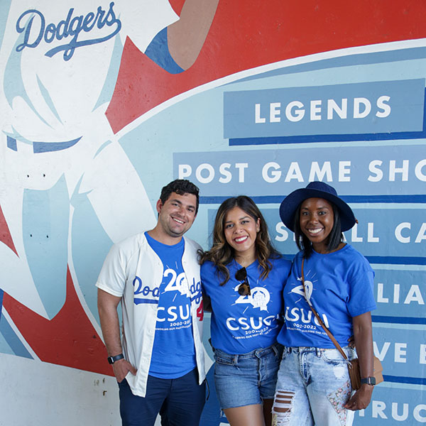 Three participants pose during CSUCI Dodger Day 2022.