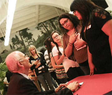 Author Gregory H. Williams greets visitors and signs copies of his book