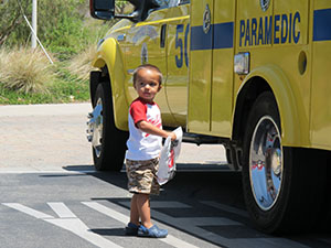 Boy by firetruck