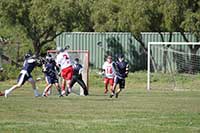 tylerlarson playing lacrosse and taking a shot at the goal