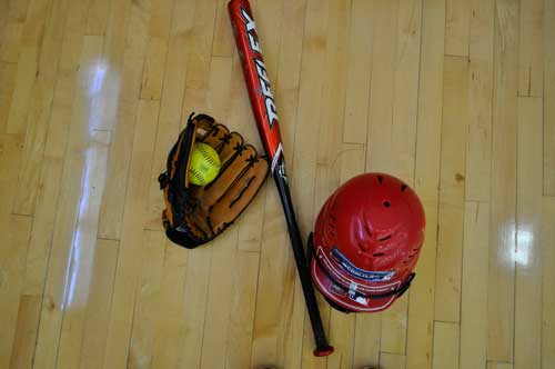 Softball bat, glove, and helmet