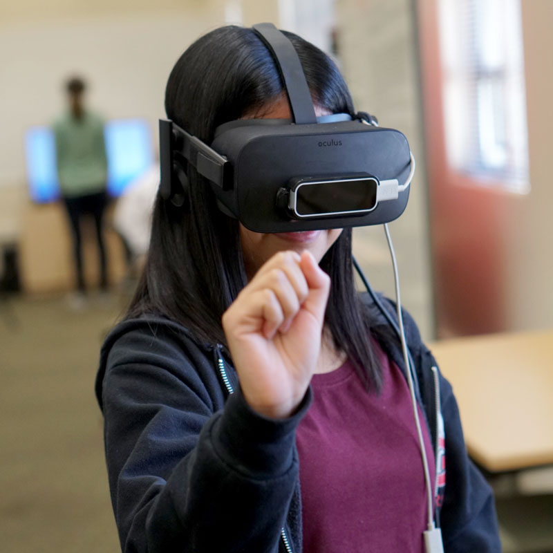 A female student participating in a virtual reality experience