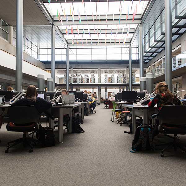 Students sitting down in a study space in a library