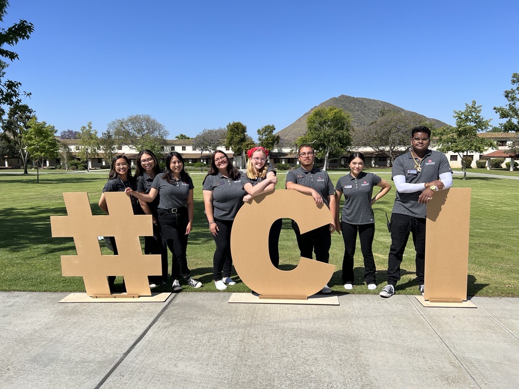 Students standing with #CI letters