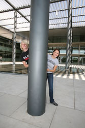 Students hiding behind pole in broome library pond area