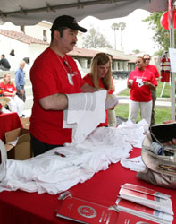 Volunteers at Table handing out t shirts