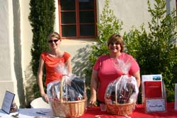 Photo of Courtney Pugh ’06 and Valerie Patscheck ’05 with gift baskets
