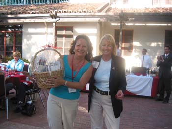 Two alumni one with a gift basket