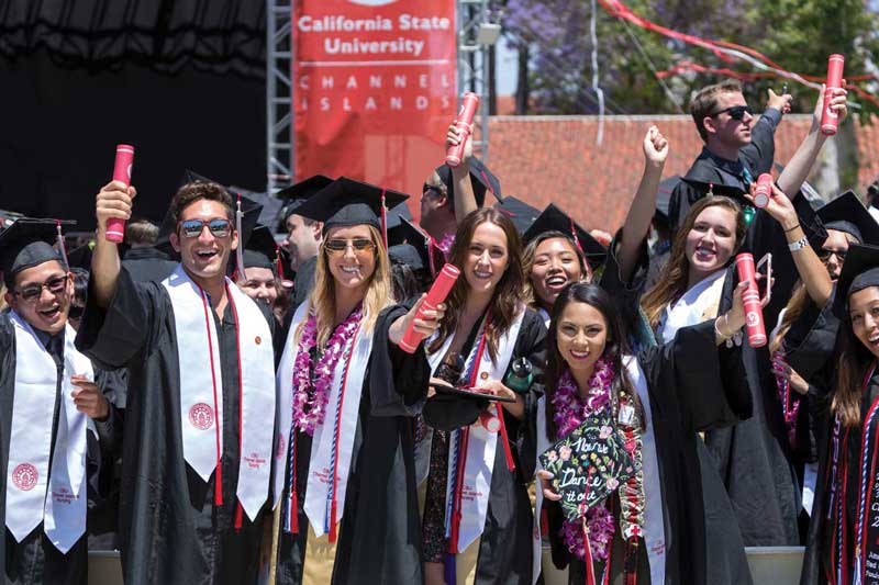 CI graduates in black cap and gowns