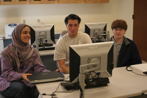 Fahimeh Fakour, Daniel Laws, Richard Yale looking at a computer