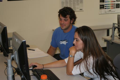 Nicole Masuda and Kelly Porter looking at a computer