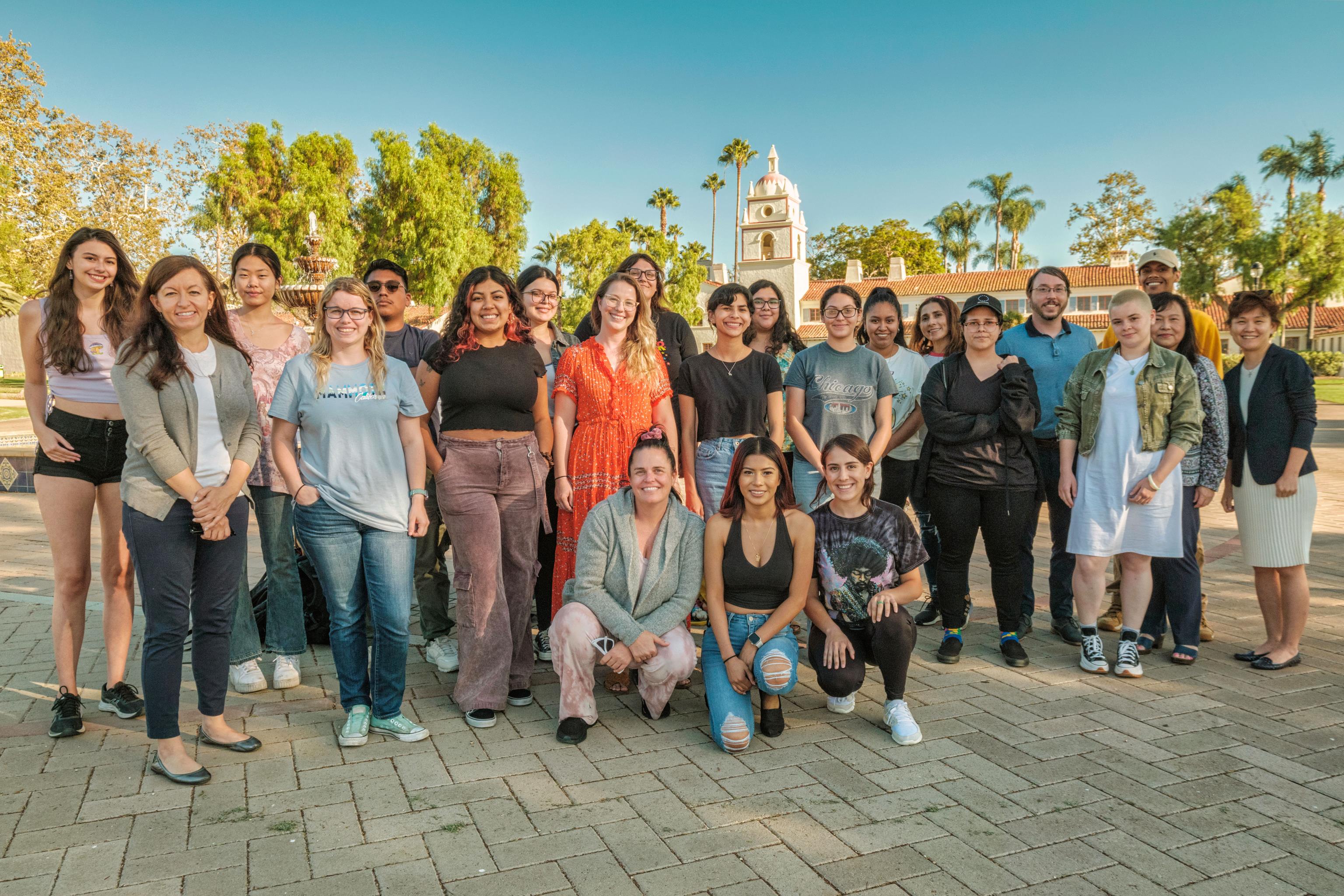 Group of TLC students and Faculty standing in front of fountain