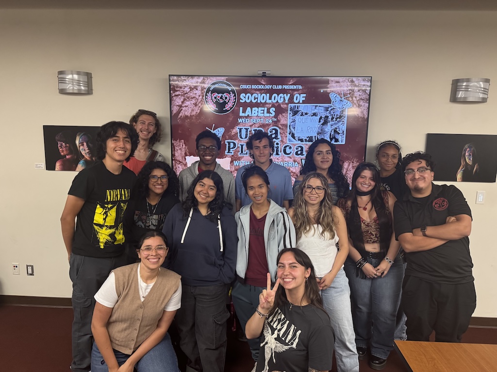 Group picture of the sociology club at a platica (talk) event they organized