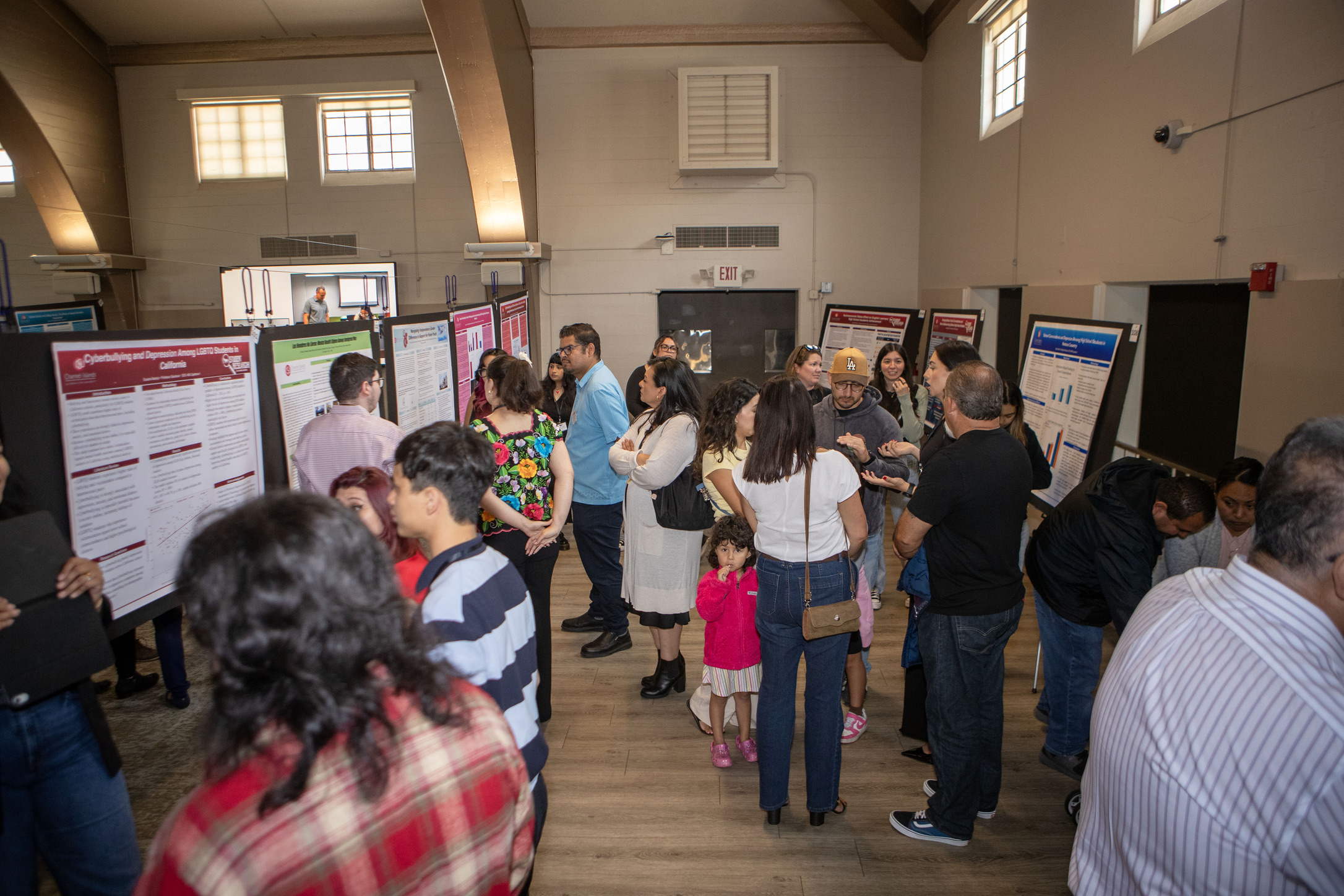 Students observing poster presentations.