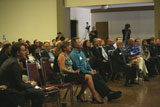 Audience members continue to look on attentively