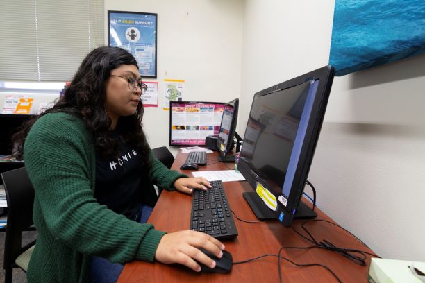 Student working at CAPS waiting room computer