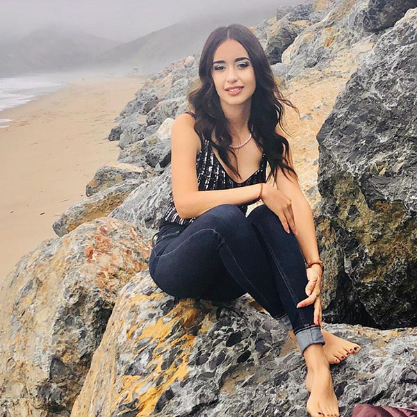 Irisela Contreras sitting on a rock at the beach