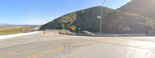 shows a mountain in the background. There is a road in the foreground.