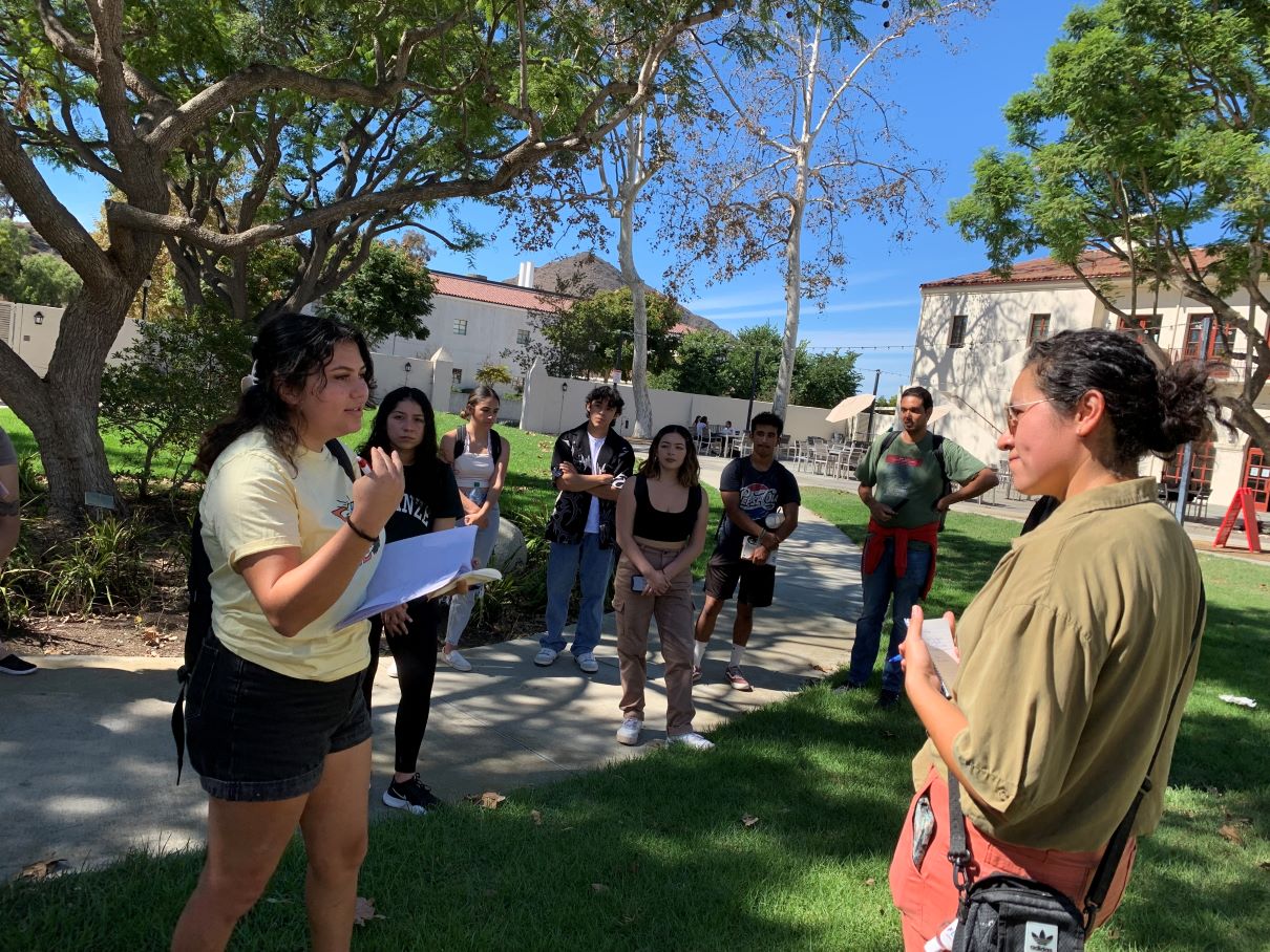 students gathered around muralist