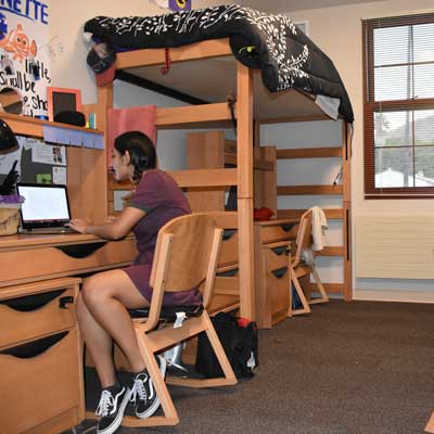 Jeanette & Cameron studying in their triple bedroom