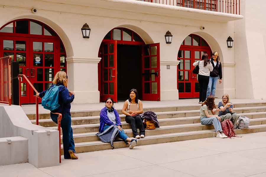 students sitting and standing and having a conversation