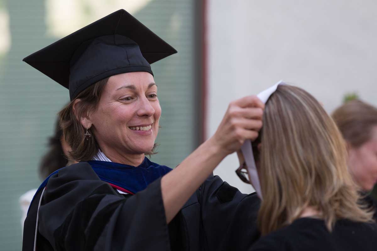 Andrea Grove presenting an award to a graduate.