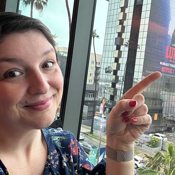 Christina Thiele-Yancy points to a Netflix building sign.