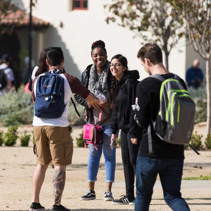 Group of students smiling on CSUCI campus