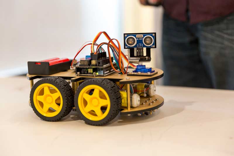 A handmade robot with large wheels 