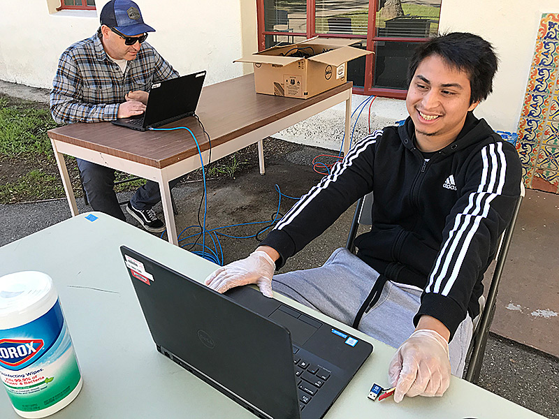 Chris Murphy and Dale Velador prep computers