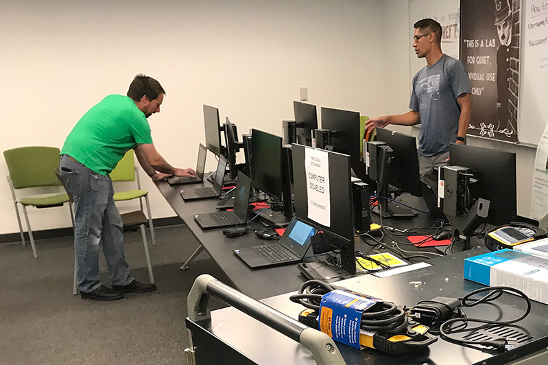 Chris Murphy and Dale Velador prep computers