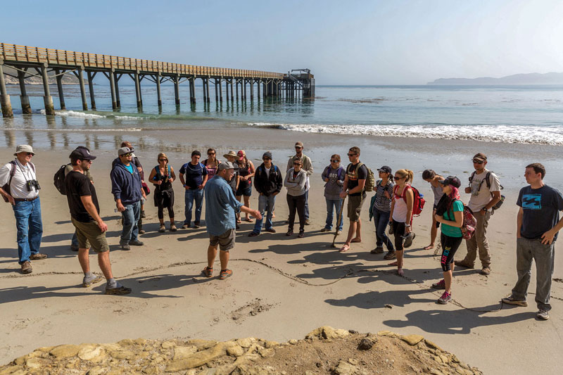 Students on a beach listening to a teacher on Santa Rosa Island.