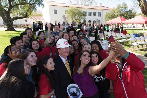 President Rush celebrates the Sierra Hall groundbreaking with students in March 2014.