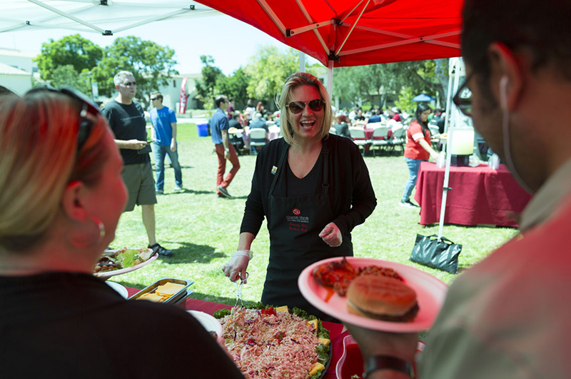 President Beck serves at the Staff & Faculty picnic