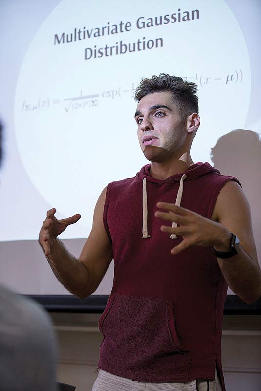 Robert Aroutiounian gives his team an overview of Quadratic Discriminant Analysis for their machine learning research project.