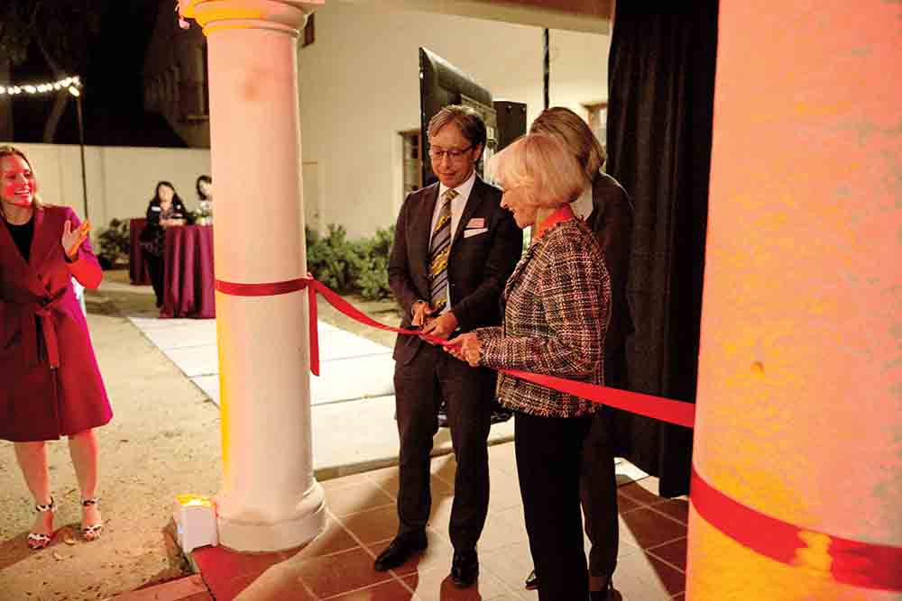 Donor Linda Dullam and Interim President Yao cut the ribbon for the courtyard