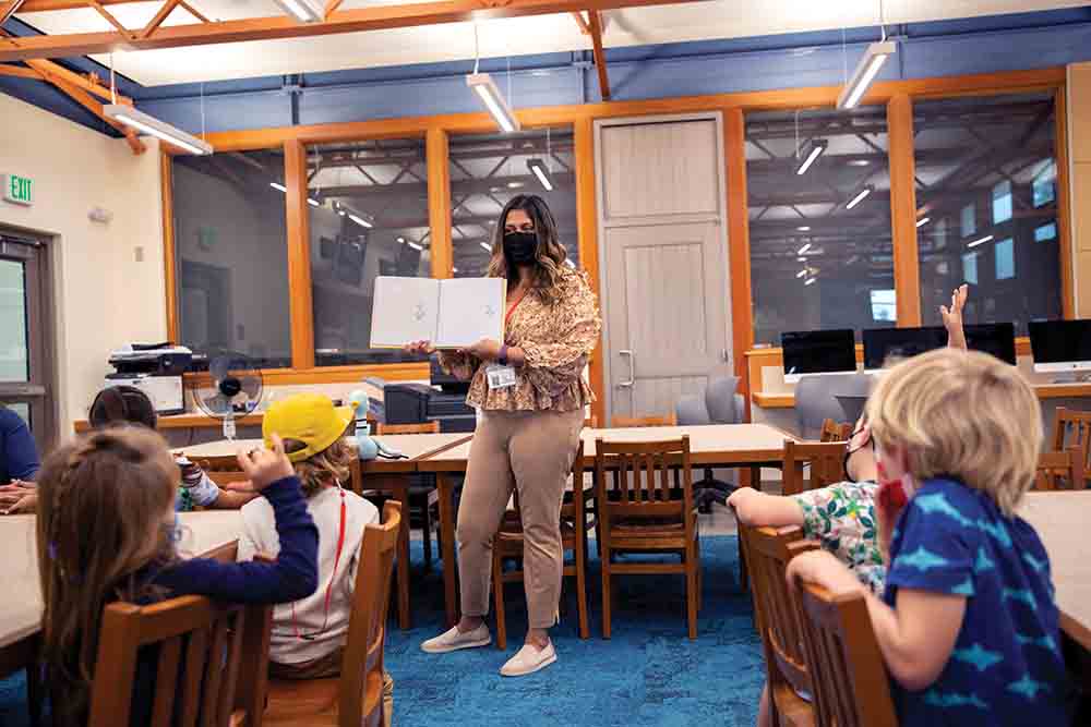 CSUCI alumna Julieta Silva Garcia leads her class out of the classroom; Garcia reads to her class at Washington Elementary School in Santa Barbara.