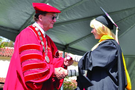 President Rush shaking students hand