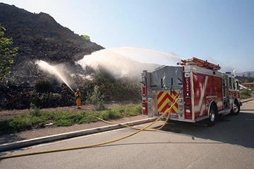 Fire trucks spray water on fire