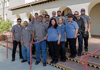 Custodial staff in front of Bell Tower