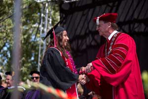 President Richard Rush congratulates graduate
