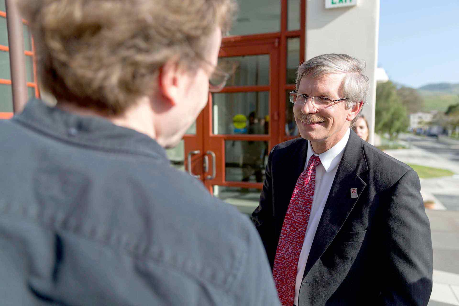 Interim Provost Daniel Wakelee greets faculty